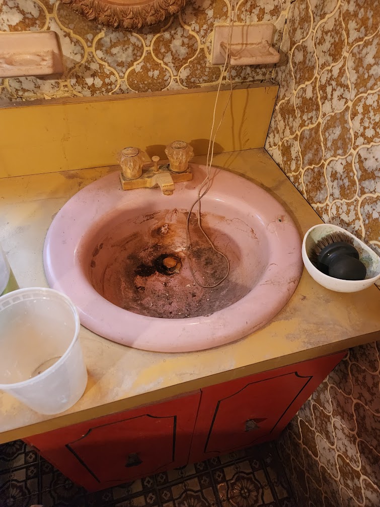 A kitchen before a deep restoration clean, looking cluttered and grimy.